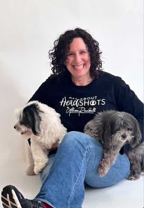 New York Dog Photographer Alissa sat in white studio with two dogs on her lap